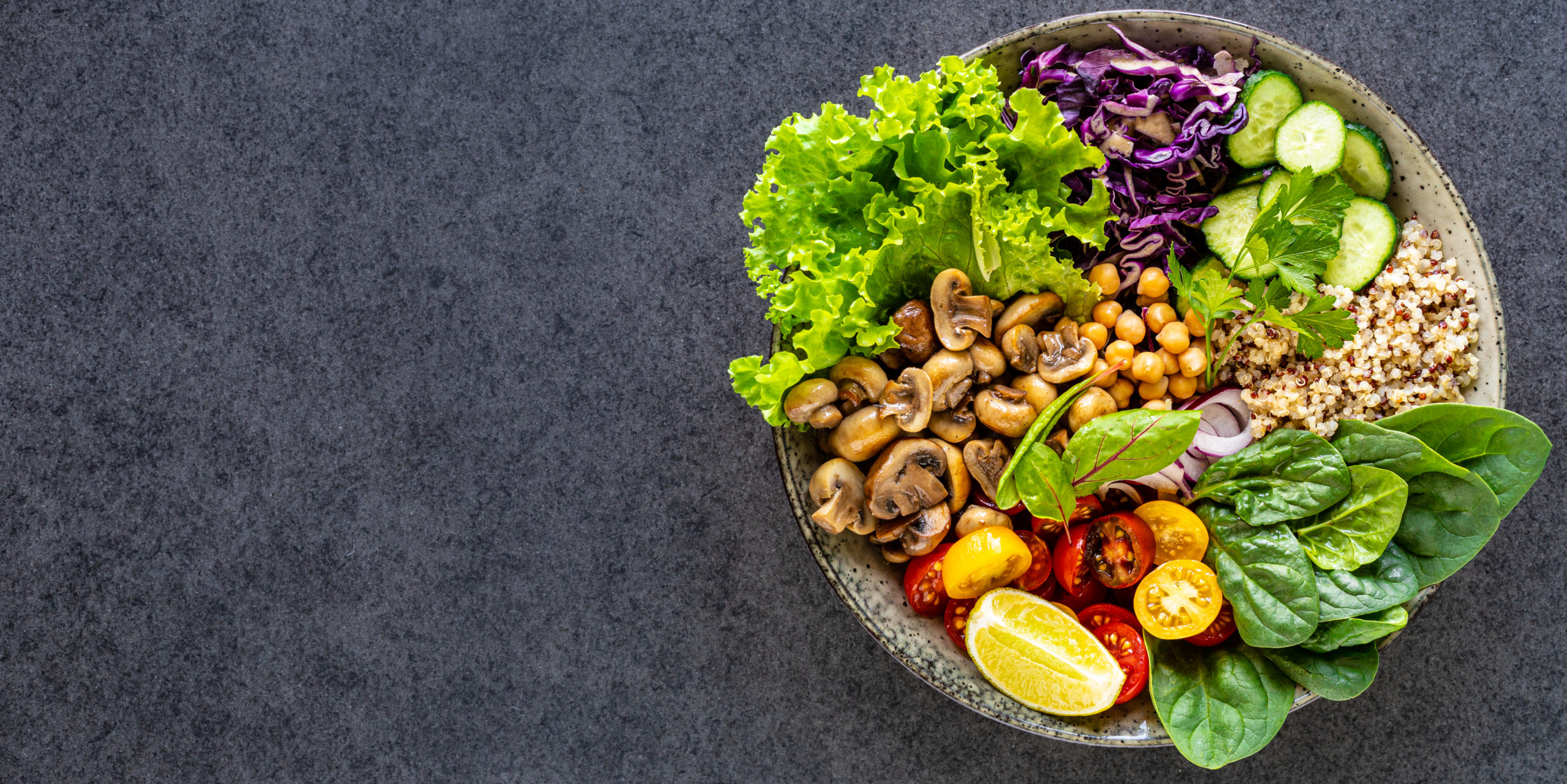 leafy foods, nuts, berries in a bowl with rich healthy food